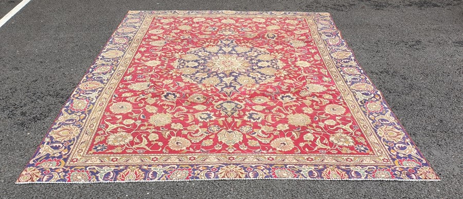 Modern antique Indian pattern carpet with central cream and blue ground stepped medallions on a pink