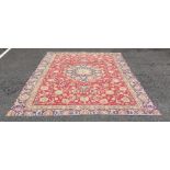 Modern antique Indian pattern carpet with central cream and blue ground stepped medallions on a pink