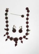 Silver-coloured metal and garnet cluster necklace, the graduated garnet cluster links with pendant