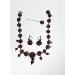 Silver-coloured metal and garnet cluster necklace, the graduated garnet cluster links with pendant