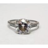 White metal and solitaire diamond ring, the circular stone 2.5ct approx, with small diamonds set
