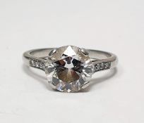 White metal and solitaire diamond ring, the circular stone 2.5ct approx, with small diamonds set