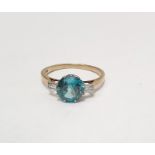 9ct gold blue stone and diamond dress ring set central blue circular stone flanked by two baguette