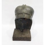 Historic replica armoured helmet on stand, engraved with trees, linear panels and dash ornament,