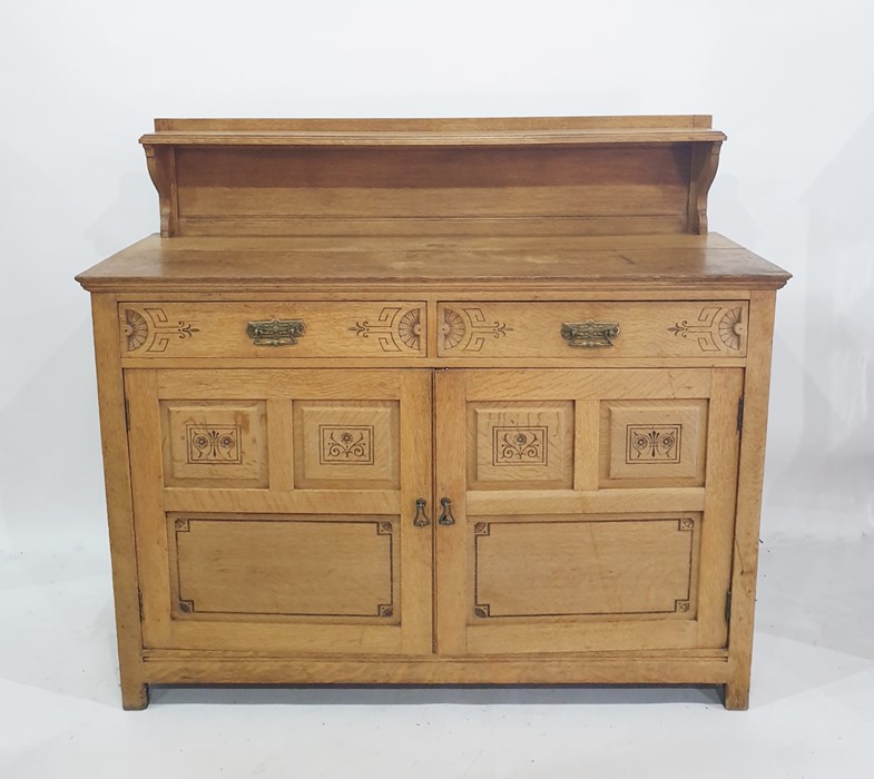 Early twentieth century oak sideboard with single shelf above rectangular top, above two drawers and