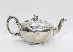 Victorian silver bullet-shaped teapot with floral engraving, pomegranate finial, raised on a