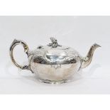 Victorian silver bullet-shaped teapot with floral engraving, pomegranate finial, raised on a