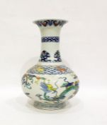 Chinese porcelain doucai vase, oviform with flared neck, decorated with dragons amongst clouds and