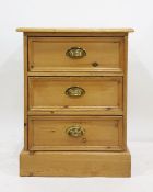 Pine three-drawer bedside chest raised on plinth base