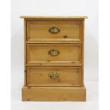 Pine three-drawer bedside chest raised on plinth base