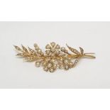 Antique gold-coloured metal and seedpearl floral spray brooch