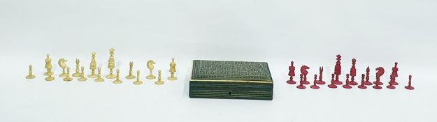 Eastern rectangular inlaid hinged box enclosing a chess set of pink and cream coloured pieces