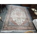Eastern rug cream ground field with pink ground central medallion, allover foliate decoration,