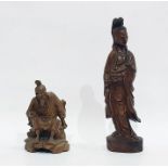 Two Chinese hardwood sculptures, the first modelled as a standing Guanyin holding a ruyi septor