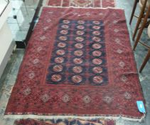 Eastern black ground rug, the central field supporting elephant foot guls, on a stepped border