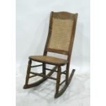 Beech framed cane seated and backed rocking chair