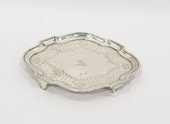 Georgian silver teapot stand with wavy edge border and floral engraving, raised on short square