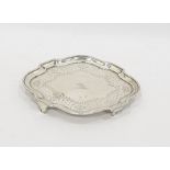 Georgian silver teapot stand with wavy edge border and floral engraving, raised on short square