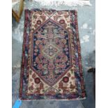 Eastern rug with diamond shaped central medallian on a blue ground foliate decorated field, cream