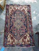 Eastern rug with diamond shaped central medallian on a blue ground foliate decorated field, cream