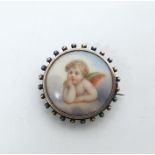 Silver, gold-plated and porcelain brooch, circular, decorated with cherub to the porcelain plaque