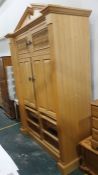 A 20th century food cupboard with broken arch pediment above two spindle-fronted doors, above two