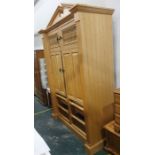 A 20th century food cupboard with broken arch pediment above two spindle-fronted doors, above two