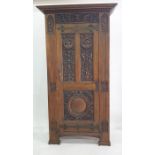 Twentieth century reproduction wardrobe in the 17th century manner, moulded and carved panels to the