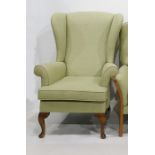 Wingback chair on cabriole supports in green upholstery