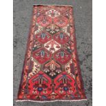 Eastern rug , central field with decorative floral panels, stepped border 248 x 105 cms