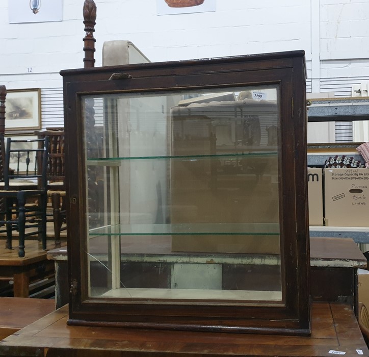 Mahogany table top display cabinet, three sided, single glazed door enclosing shelves, on plinth