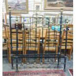 A iron & brass four foot bed frame raised upon brown china castors