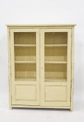 Cream painted food cupboard, the wire grill fronted doors enclosing shelves 84 x 108.5