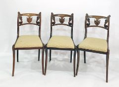 Set of four Regency simulated roseewood dining chairs with anthemion and scroll carved backs, gold