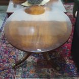 A twentieth century oval mahogany coffee table on turned supports to four reeded legs, terminating