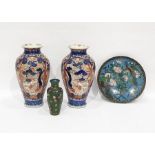 A pair of Japanese Imari pattern baluster vases painted in underglaze blue with trees and scrolls,