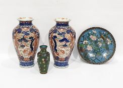 A pair of Japanese Imari pattern baluster vases painted in underglaze blue with trees and scrolls,