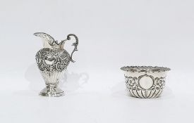 Victorian silver cream jug with foliate scrollwork decoration, raised on a circular foot, Birmingham