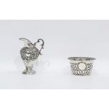 Victorian silver cream jug with foliate scrollwork decoration, raised on a circular foot, Birmingham