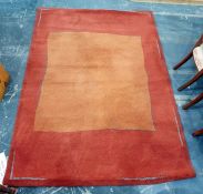 Modern orange and red ground rug 167 x  237 cms