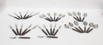 A set of stainless cutlery (Thomas W. Cork & Son) for six people mounted with dark stained wooden