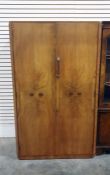 Twentieth century walnut compactum, two doors flanked by canted corners 90.5 x 152.5 cms