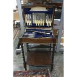 A near complete 6 place canteen of cutlery, cased in an oak side table on barley twist legs with