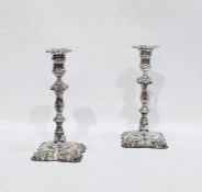 Pair of silver plated George III style candlesticks, each with foliate cast square section removable