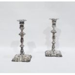 Pair of silver plated George III style candlesticks, each with foliate cast square section removable