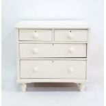 A white painted chest two short over two long drawers raised upon turned supports 83 x 83cm