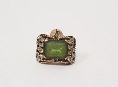 Gold-coloured metal, diamond and green stone dress ring, the rectangular green stone worn,