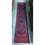 Eastern runner, five diamond shaped central medallians on a stepped border 203 x 58 cms