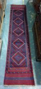 Eastern runner, five diamond shaped central medallians on a stepped border 203 x 58 cms