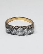 Antique gold-coloured metal five-stone diamond ring set with old cut stones, the centre stone 0.